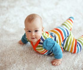 Baby lying on the carpet Stock Photo