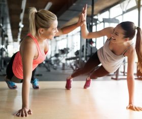 Best friend encourages exercise in the gym Stock Photo