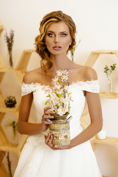Blonde pretty woman holding flower arrangement Stock Photo 01