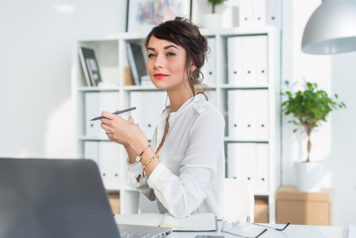Business woman drinking coffee in the office Stock Photo