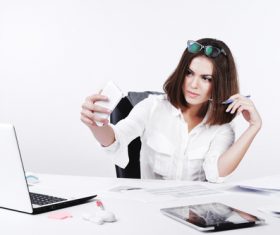 Business woman using cell phone in the office selfie 02