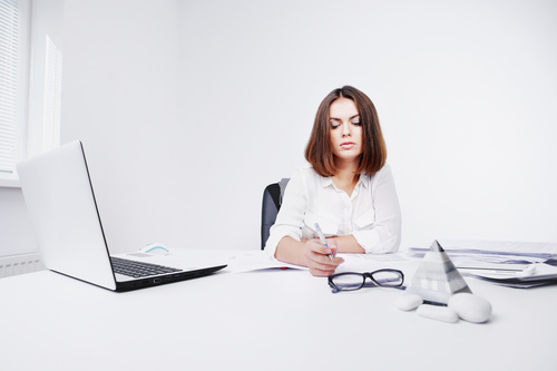 Businesswoman looking at documents on the desk Stock Photo 03
