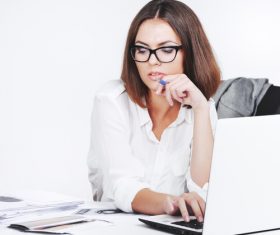 Businesswoman using laptop in office Stock Photo 01