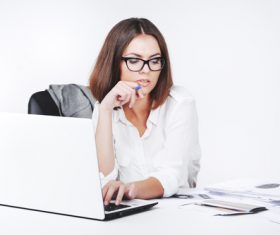 Businesswoman using laptop in office Stock Photo 02