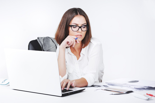 Businesswoman using laptop in office Stock Photo 02