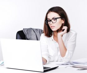 Businesswoman using laptop in office Stock Photo 03