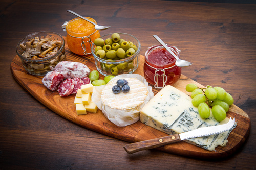 Cheese jam and sausage with pickled olives on cutting board Stock Photo 01