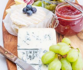 Cheese jam and sausage with pickled olives on cutting board Stock Photo 02