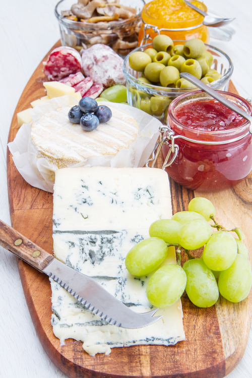 Cheese jam and sausage with pickled olives on cutting board Stock Photo 02