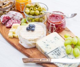 Cheese jam and sausage with pickled olives on cutting board Stock Photo 03