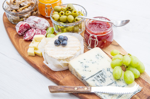 Cheese jam and sausage with pickled olives on cutting board Stock Photo 03