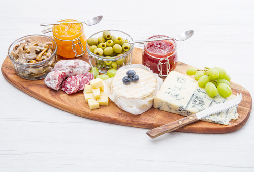 Cheese jam and sausage with pickled olives on cutting board Stock Photo 04