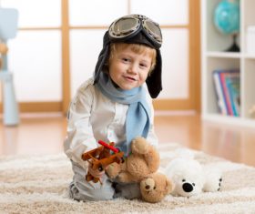 Child holding teddy bear play wooden plane Stock Photo 03