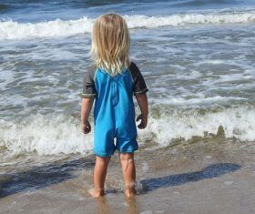 Child playing with water at the beach Stock Photo