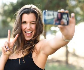 Confident beautiful woman taking a selfie Stock Photo