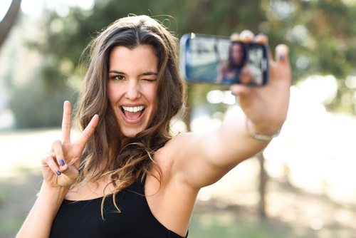 Confident beautiful woman taking a selfie Stock Photo