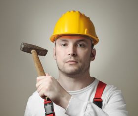 Construction worker holding hammer men Stock Photo