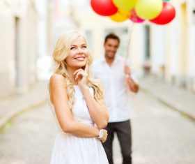 Couple holding colorful balloons on the street Stock Photo 03
