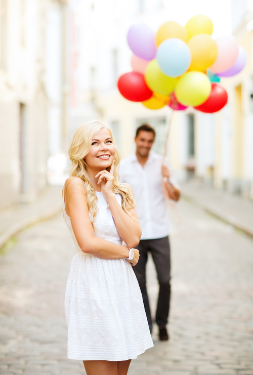 Couple holding colorful balloons on the street Stock Photo 03