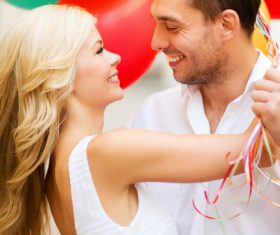 Couple holding colorful balloons on the street Stock Photo 05