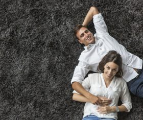 Couple lying on the carpet Stock Photo