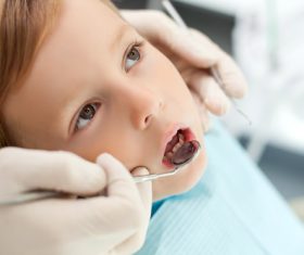 Dentist examines childrens teeth Stock Photo 01
