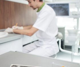 Dentist makes records and dental equipment on the desktop Stock Photo