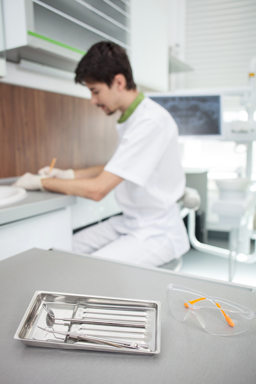Dentist makes records and dental equipment on the desktop Stock Photo