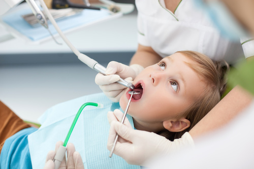 Dentist treats tooth decay for little boy Stock Photo 02