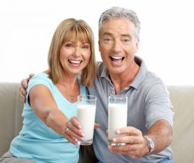 Elderly couple holding milk in hand Stock Photo