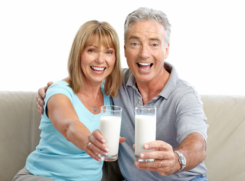 Elderly couple holding milk in hand Stock Photo
