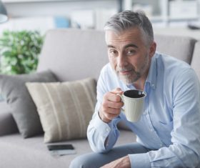 Elderly man drinking coffee Stock Photo