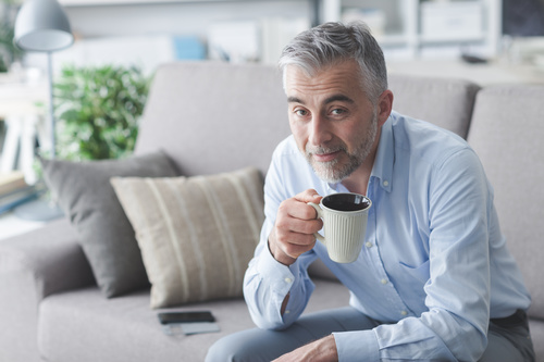 Elderly man drinking coffee Stock Photo