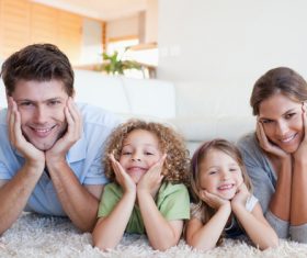 Family lying on the carpet Stock Photo