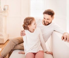 Father and daughter sitting on the couch Stock Photo