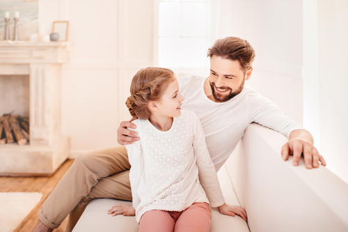 Father and daughter sitting on the couch Stock Photo