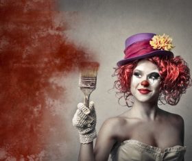 Female clown holding a brush Stock Photo