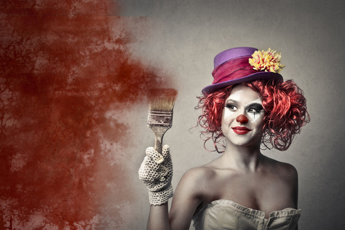 Female clown holding a brush Stock Photo