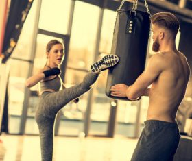 Female kicking sandbag Stock Photo 02