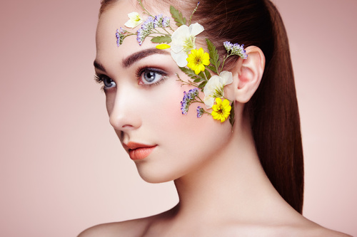 Female model facial flower decoration Stock Photo
