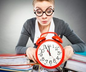 Female secretary and alarm clock Stock Photo 01