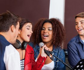 Friends gather together to sing Stock Photo