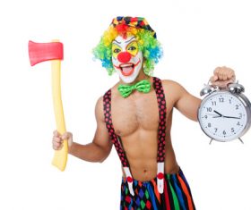 Funny clown holding an axe and alarm clock Stock Photo