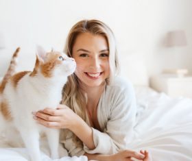 Girl and cat on the bed Stock Photo 01