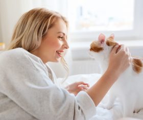 Girl and cat on the bed Stock Photo 02