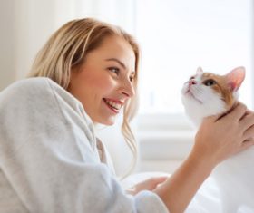 Girl and cat on the bed Stock Photo 04