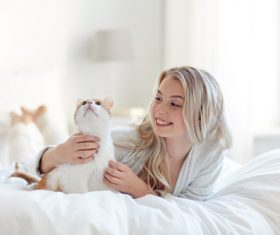 Girl and cat on the bed Stock Photo 05