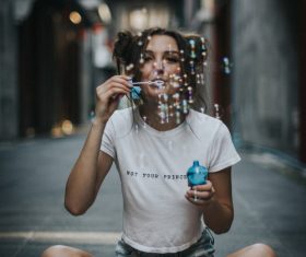 Girl blowing bubbles Stock Photo