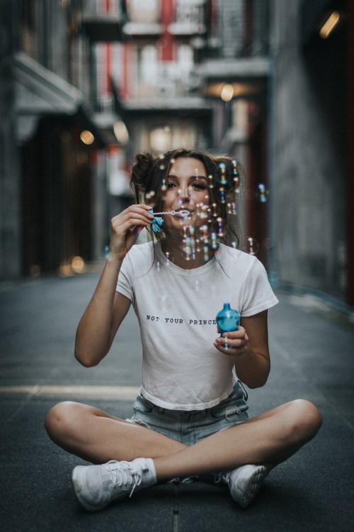 Girl blowing bubbles Stock Photo