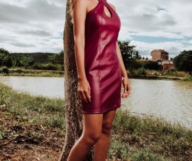 Girl in red leather skirt by the river Stock Photo
